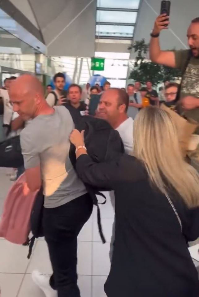 Anthony Taylor excorted out of Budapest airport by security personnel amidst a flood of angry Roma fans. 